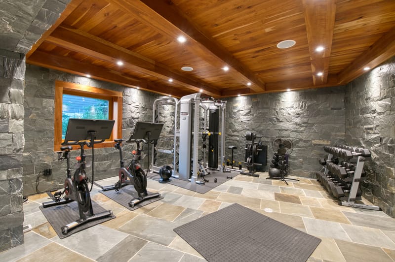 Home gym with Peloton bikes and weight equipment