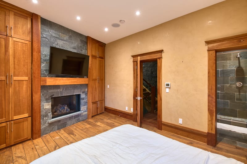 Lower-level media room with a fireplace