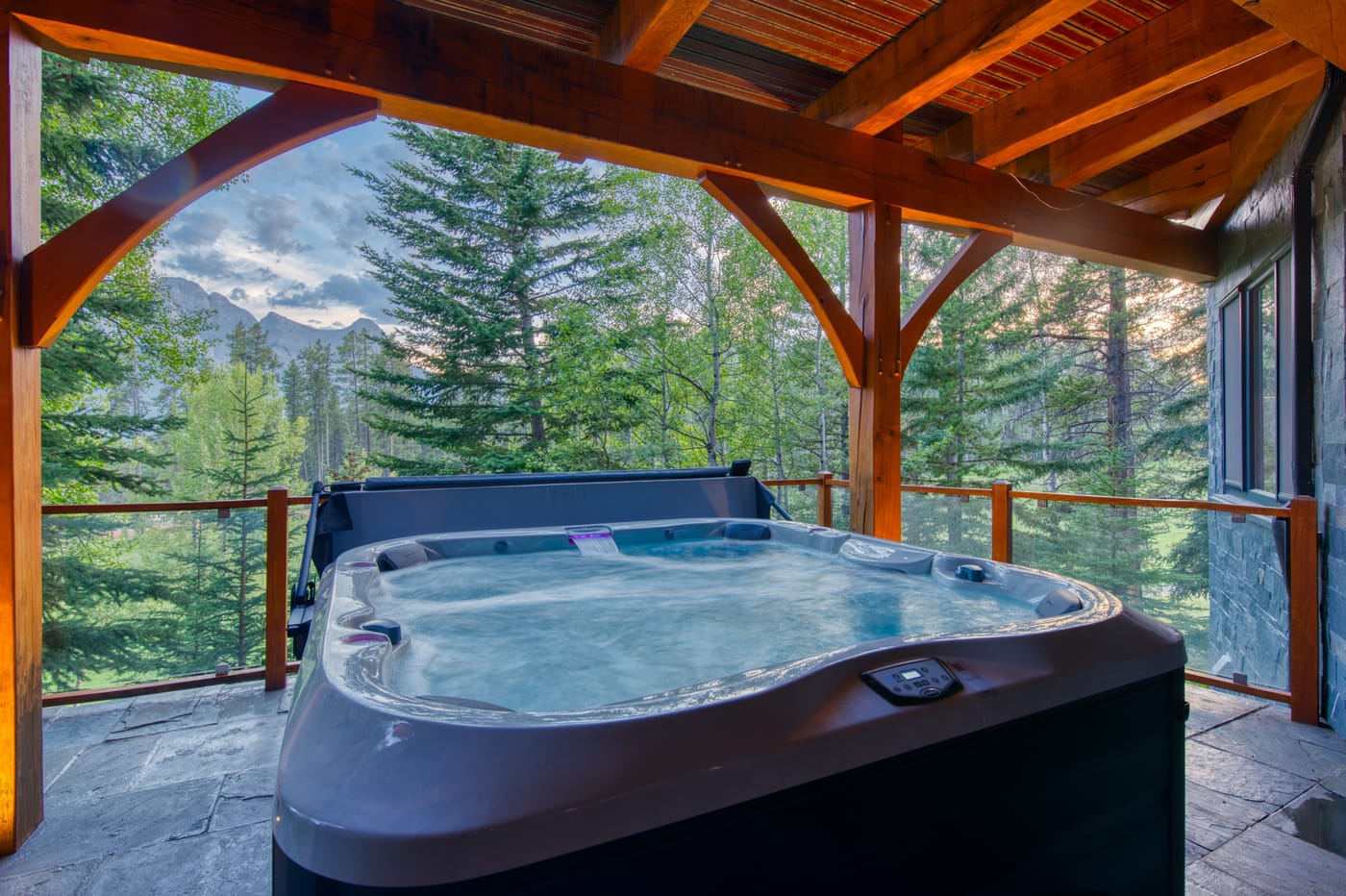 Covered deck hot tub under the mountain sky