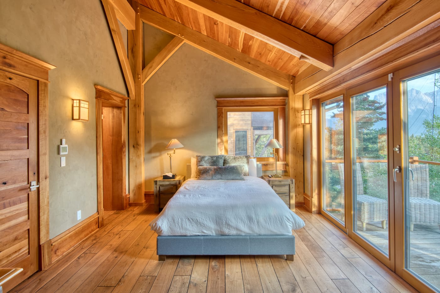 Guest bedroom with warm timber accents and mountain views