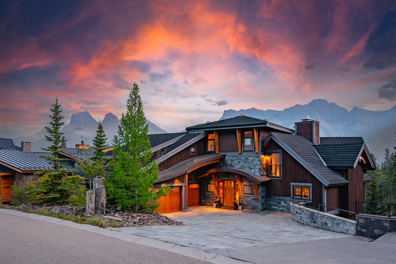 821 Silvertip Heights luxury lodge at dusk beneath the Three Sisters, Canmore